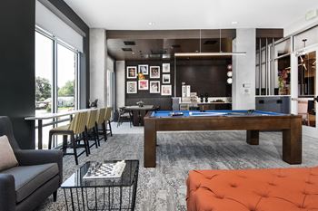 Clubhouse with sitting areas, tv, kitchen, and billiard table